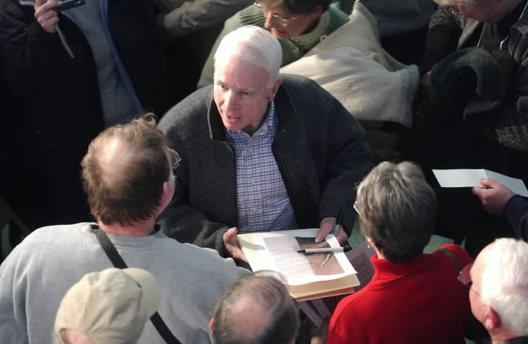 McCain signs autographs